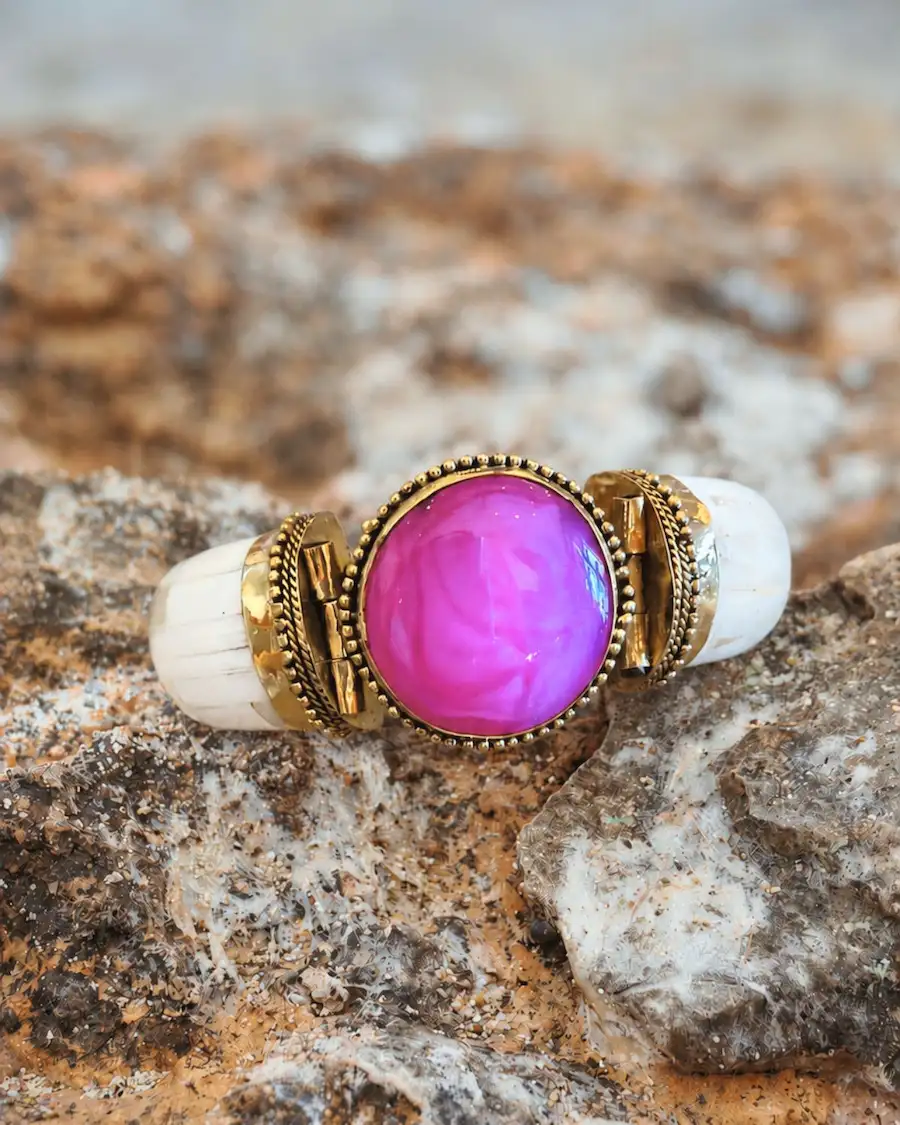 Brazalete artesanal mediterráneo con piedra magenta vibrante.